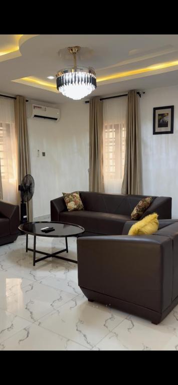 a living room with a couch and a table at Oak Serviced Apartment-New Bodija in Ibadan