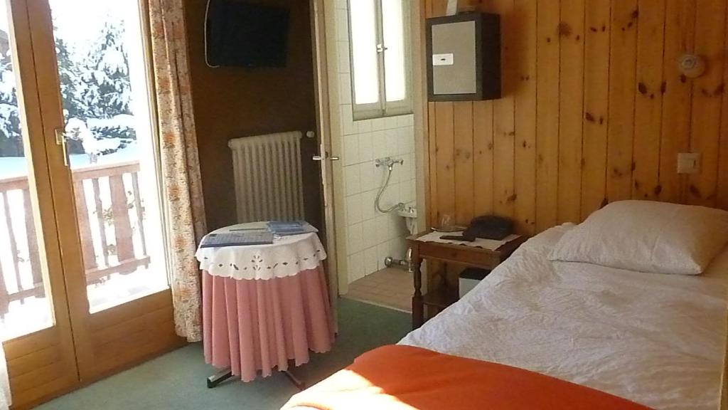 Postel nebo postele na pokoji v ubytování Hotel de la Poste Verbier