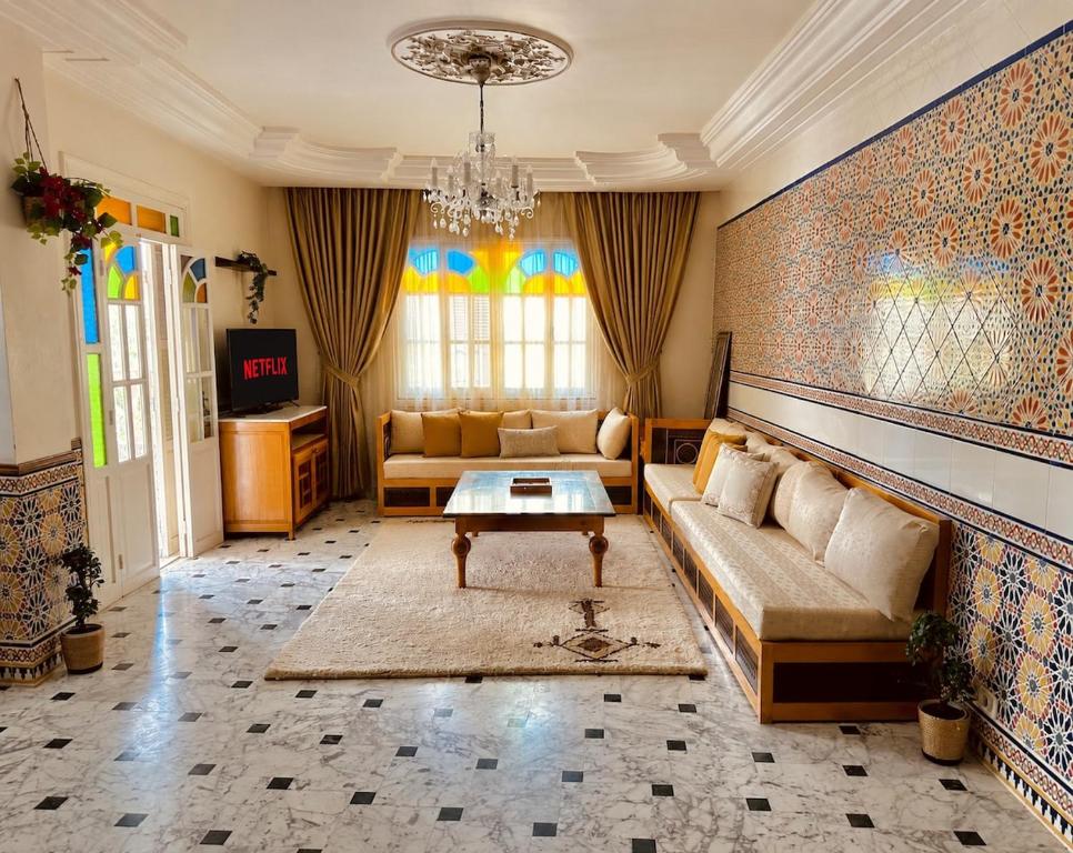 a living room with a couch and a table at Dar Joud in Gabès