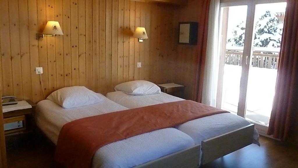 Postel nebo postele na pokoji v ubytování Hotel de la Poste Verbier