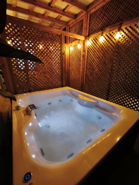 a bath tub in a bathroom with lights at Casa Marina Sotomayor in Santiago
