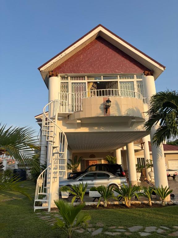 a house with a car parked in front of it at Nyaniba Villa in Accra