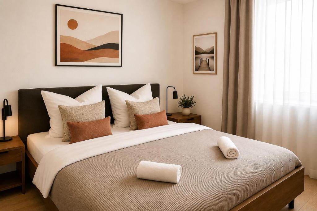 a bedroom with a large bed with brown and white pillows at Wohnung in Siegen Parkplatz WLAN Autobahn in Wilnsdorf