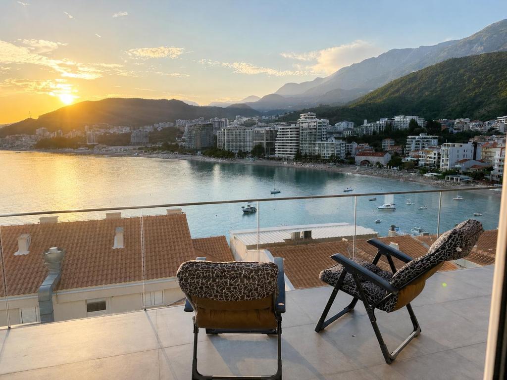 a balcony with two chairs and a view of a city at Panorama Chill in Rafailovici