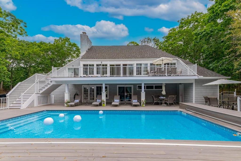 a home with a swimming pool and a house at Southampton Beauty in Southampton