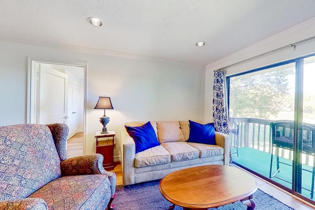 a living room with a couch and a table at Tranquility on the Lake in Montgomery