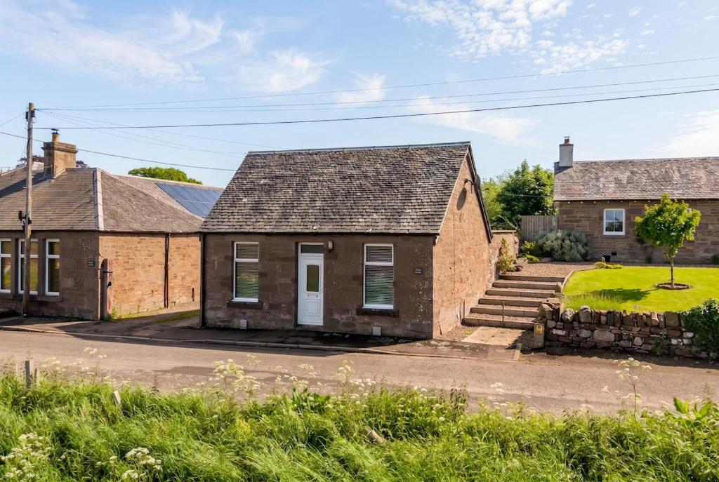 an old brick house with a staircase in front of it at Home in Perth and Kinross in Coupar Angus