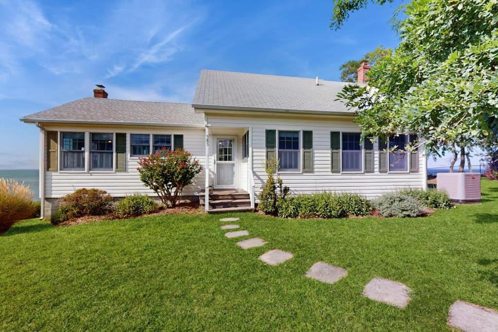 a white house with a lawn in front of it at North Fork Waterfront Gem in East Marion