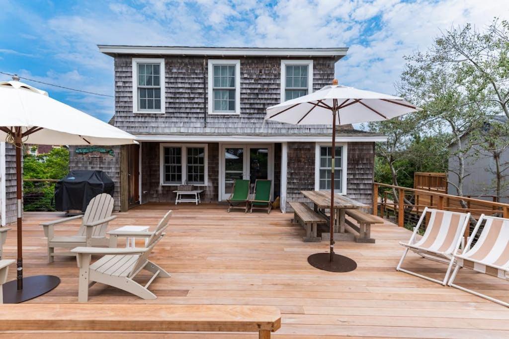 a deck with chairs and tables and umbrellas at Seaside Escape on Huron in Ocean Beach