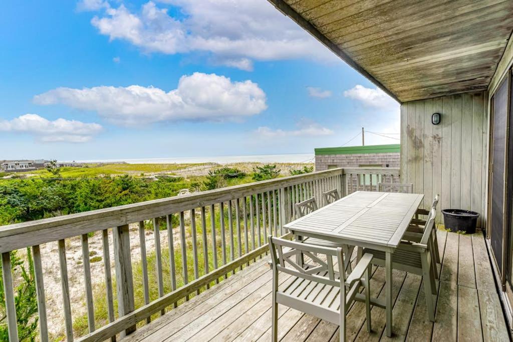 a wooden deck with a table and chairs on it at Robbins Rest Retreat in Ocean Beach