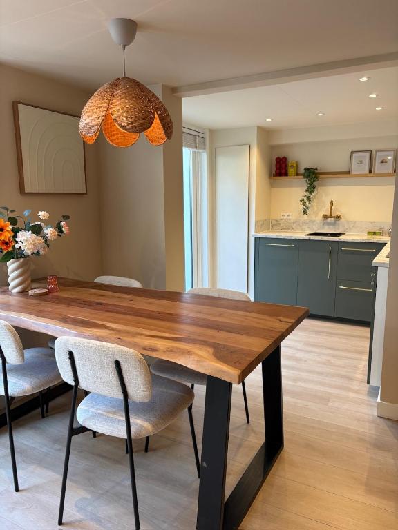 a dining room with a wooden table and chairs at Salty dunes in Noordwijk
