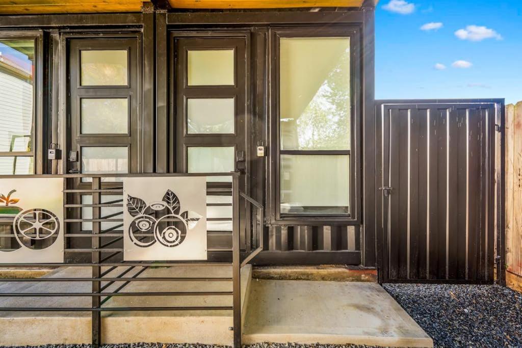 a front door of a house with windows at Blueberry Container at EADO Juicebox in Houston