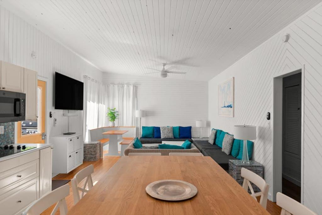 a living room with a table and a couch at 10 Cayuga in Ocean Bay Park