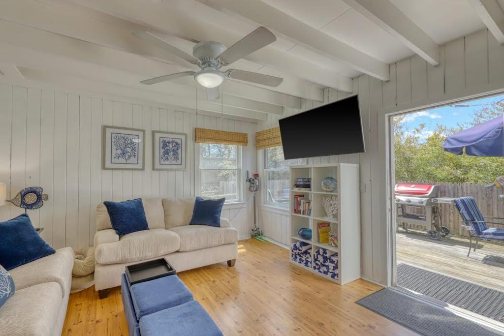 a living room with a couch and a ceiling fan at The Surfcomber Unit 3 in Ocean Bay Park
