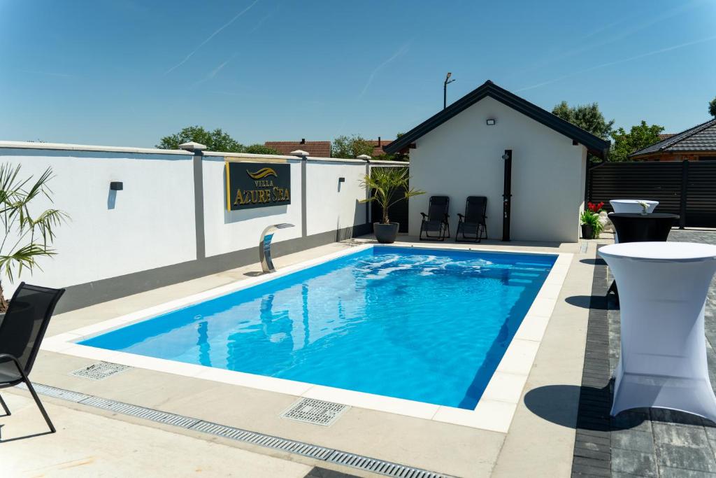 a swimming pool in the backyard of a house at Villa Azure Sea in Bijeljina