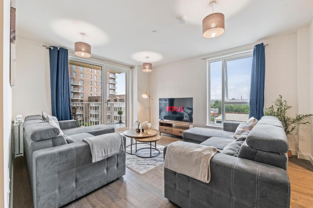 a living room with two couches and a tv at Luxury 2BR Apartment I Sleep 8 I Direct to Wembley & Euston in Hatch End