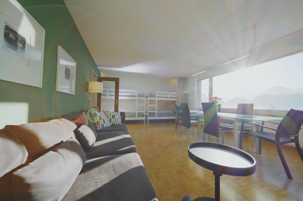 a living room with a couch and a table at Traumhafte 2,5-Zi-Wohnung -B- mit Sicht auf See und Berge in Alpnach