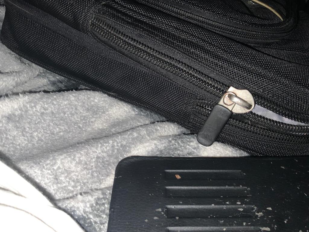 a black suitcase with a zipper on the floor at Ravine Retreat in Valparaiso