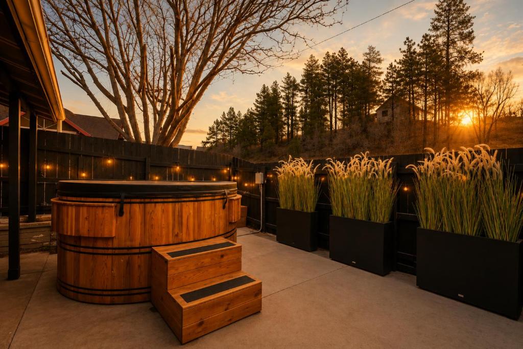 a hot tub in a garden with some tall grass at Adventure Inn Durango in Durango