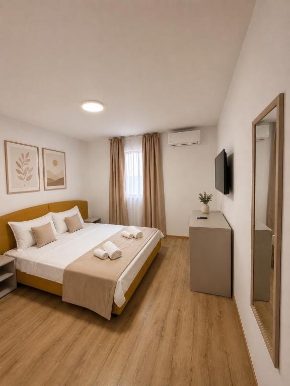 a bedroom with a bed with two towels on it at Hostel Oltenia in Eforie Sud