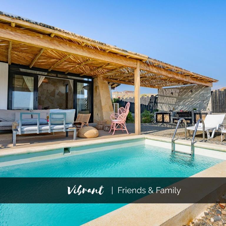 a house with a swimming pool and a pavilion at Casa Arte by Vibrant in Vichayito