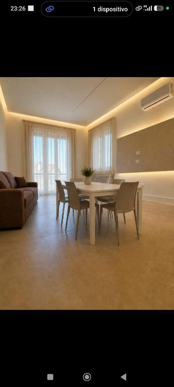 a living room with a table and chairs and a couch at La casa del sole in Trofarello