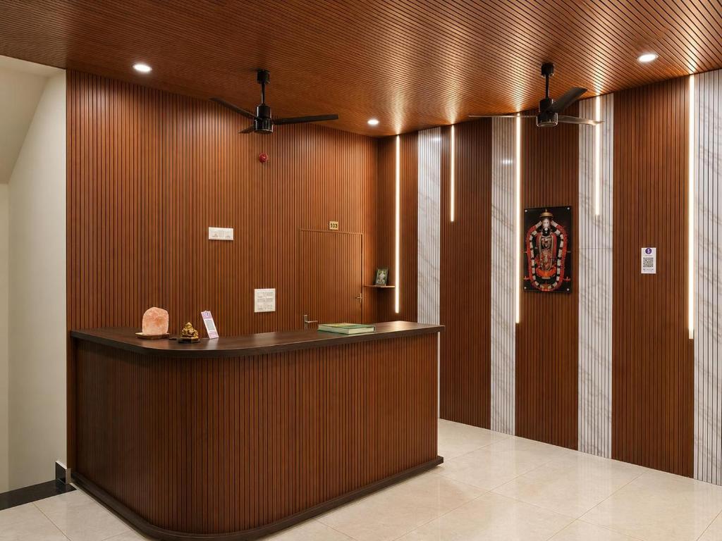 a hotel lobby with a reception counter at JK Suites in Rāmachandrapuram