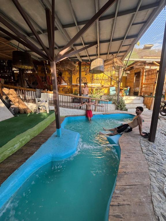 a group of children playing in a swimming pool at Mar y Montana in Taganga