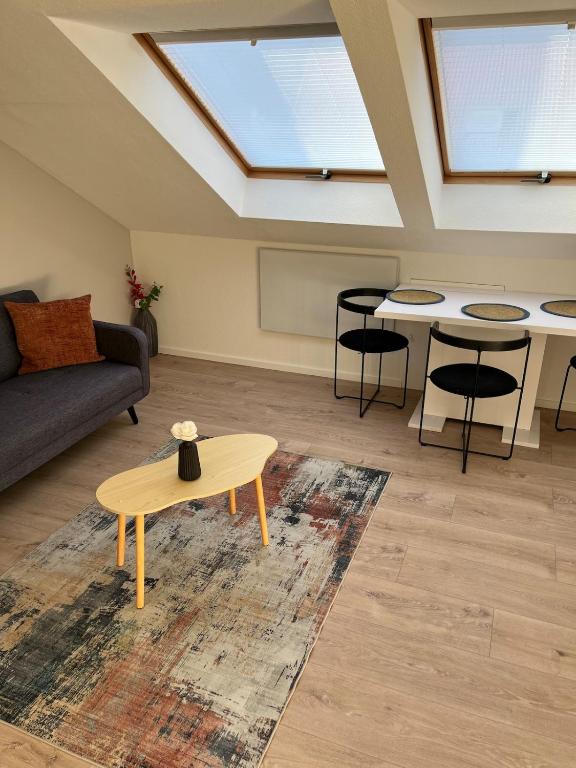 a living room with a couch and a table at Stylish & modern Flat with large Sun Balcony in Bad Peterstal