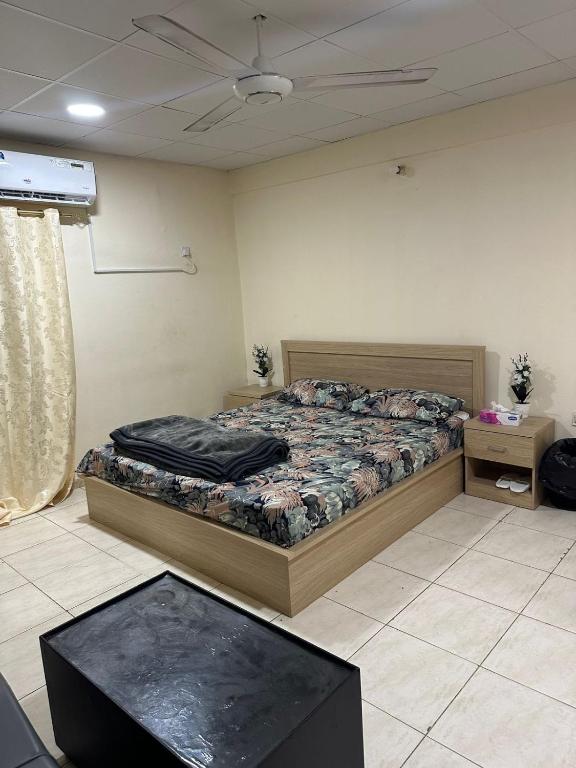 a bedroom with a bed and a table in it at Khan property in Islamabad