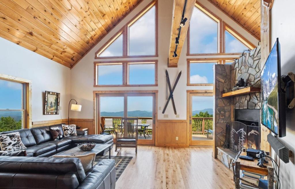 a living room with a couch and a fireplace at Pinecone Manor Beech Mountain in Beech Mountain