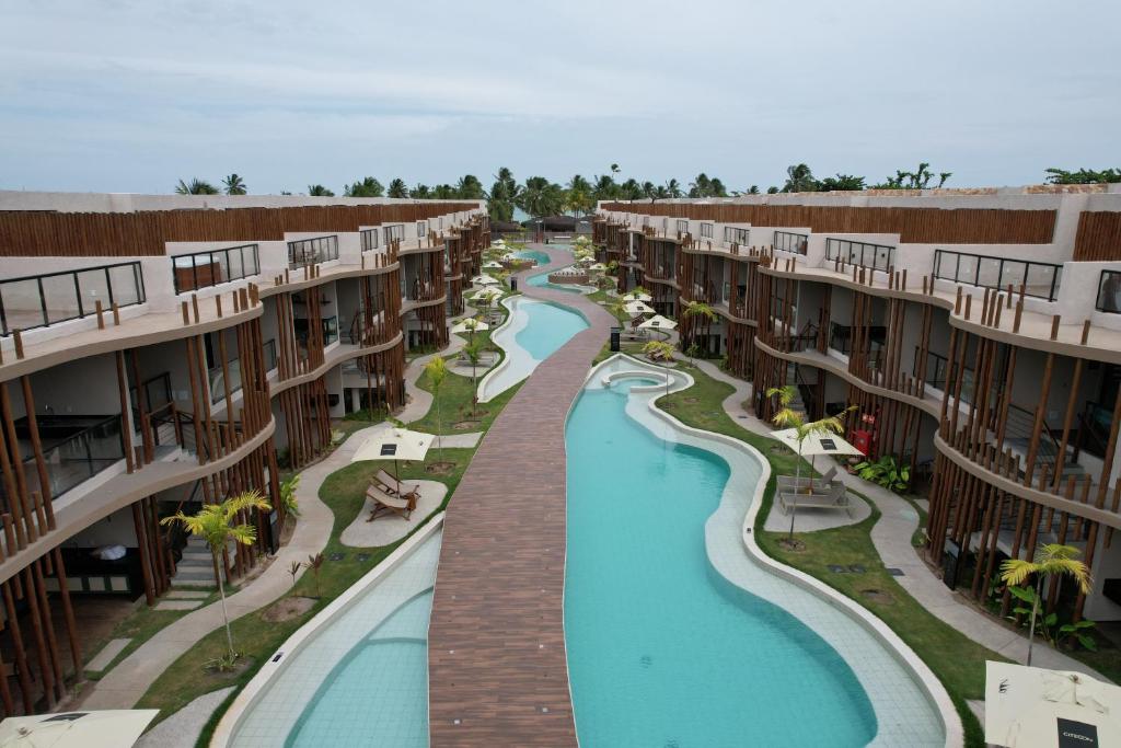 an aerial view of a swimming pool at a resort at Condo with Beach Access By MME in Tatuamunha