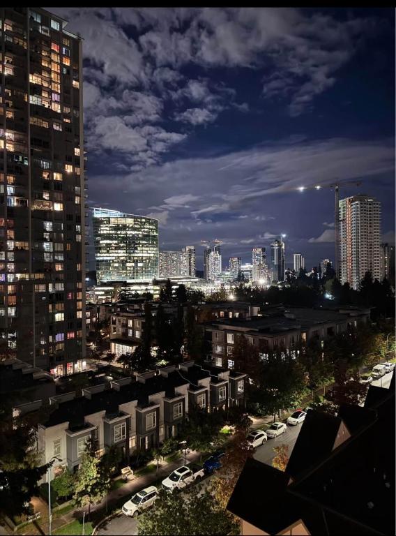 a city skyline at night with tall buildings at Cozy 1 bed executive suit in Surrey