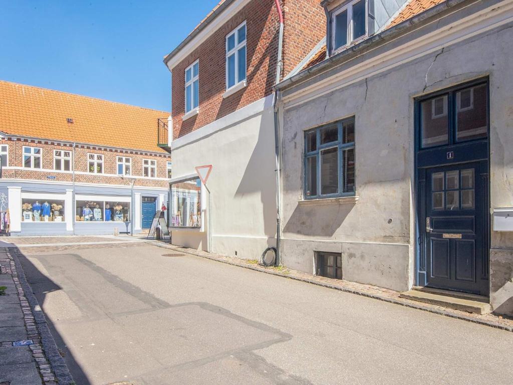 an empty street in front of a building at 2 person holiday home in Ringkøbing in Ringkøbing