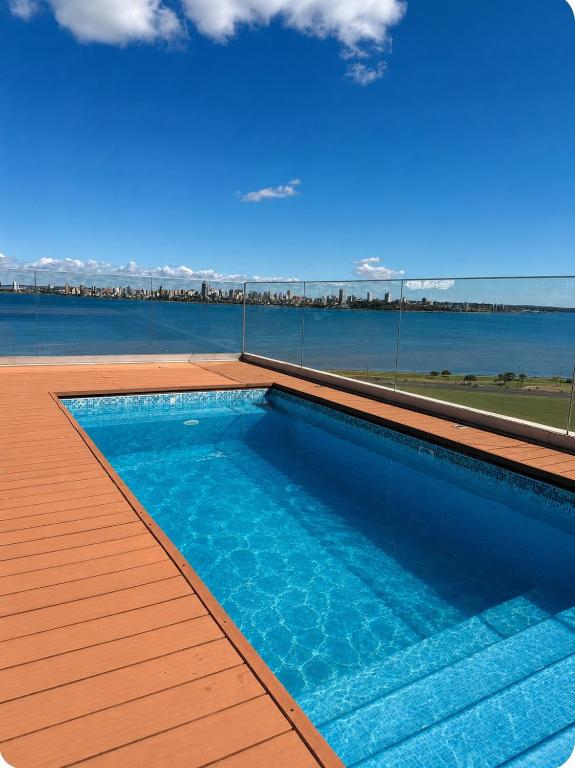a swimming pool on the roof of a house at Apartamento completamente equipado! Con Parking! En Paraná Playa Deptos! in Encarnación