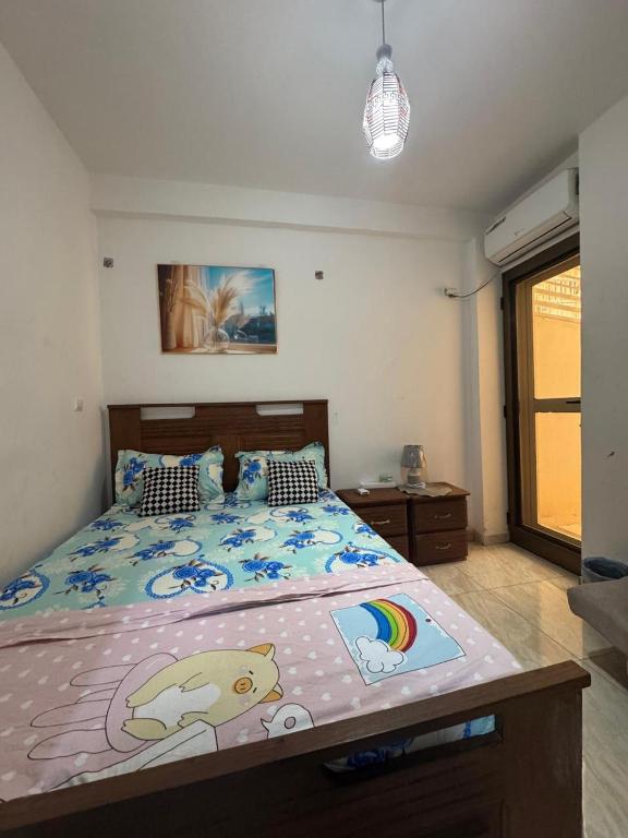 a bedroom with a large bed with a hello kitty comforter at The Sonu Nest in Dakar