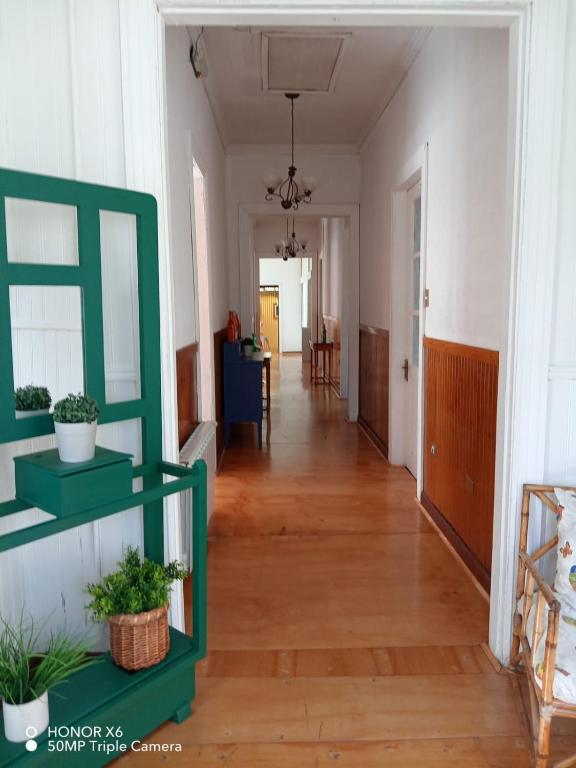 a hallway of a home with a green shelf at ayelen bed and breakfast in Punta Arenas
