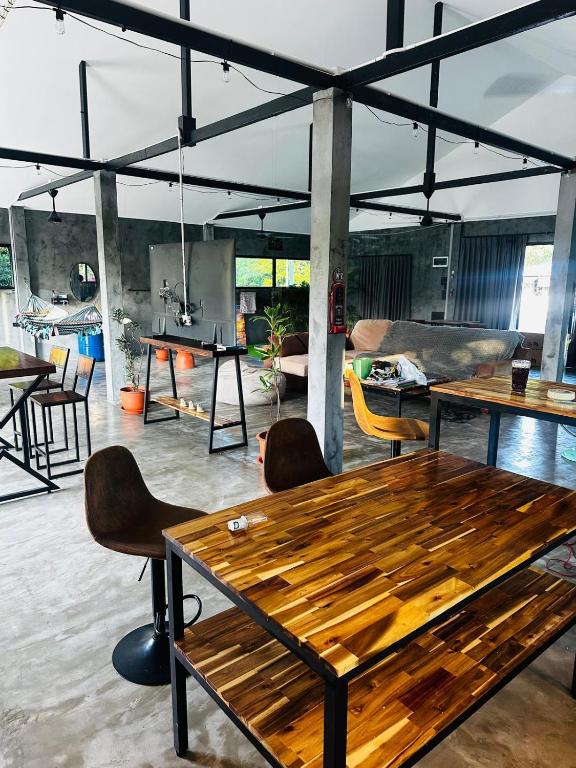a room with a wooden table and chairs at Loft at Rawaï Beach in Nai Harn Beach