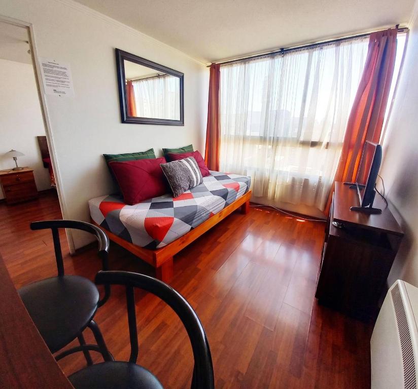 a living room with a couch and a television at Metroapart 1 a un min del metro in Santiago