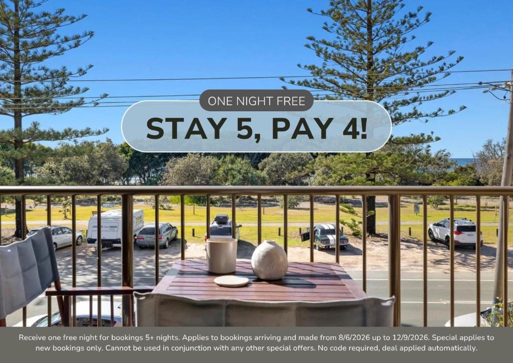 a sign that reads one night free stays pay on a balcony at Seaside Getaway on Kingscliff Beach in Kingscliff