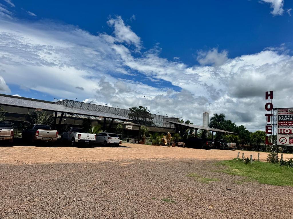 a gas station with cars parked in front of it at Querência Pantaneira in Miranda
