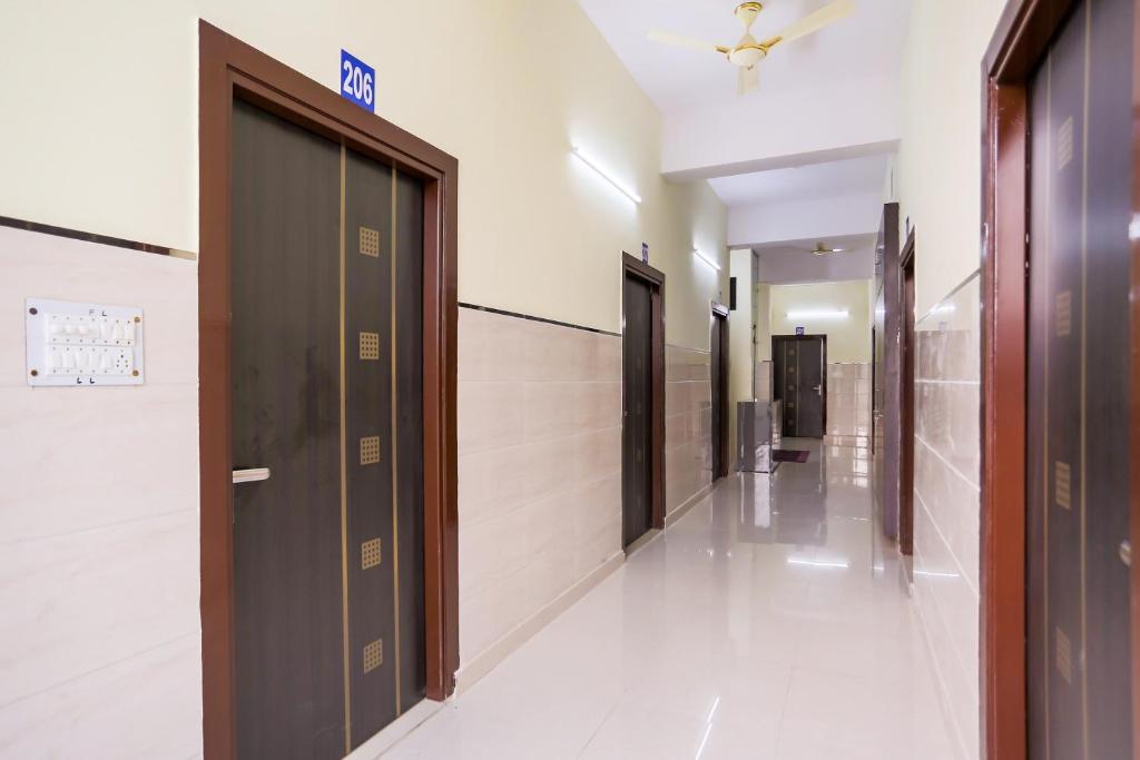 a hallway of elevators in a building at Super Hotel O Viraj Deluxe Narela in Delhi