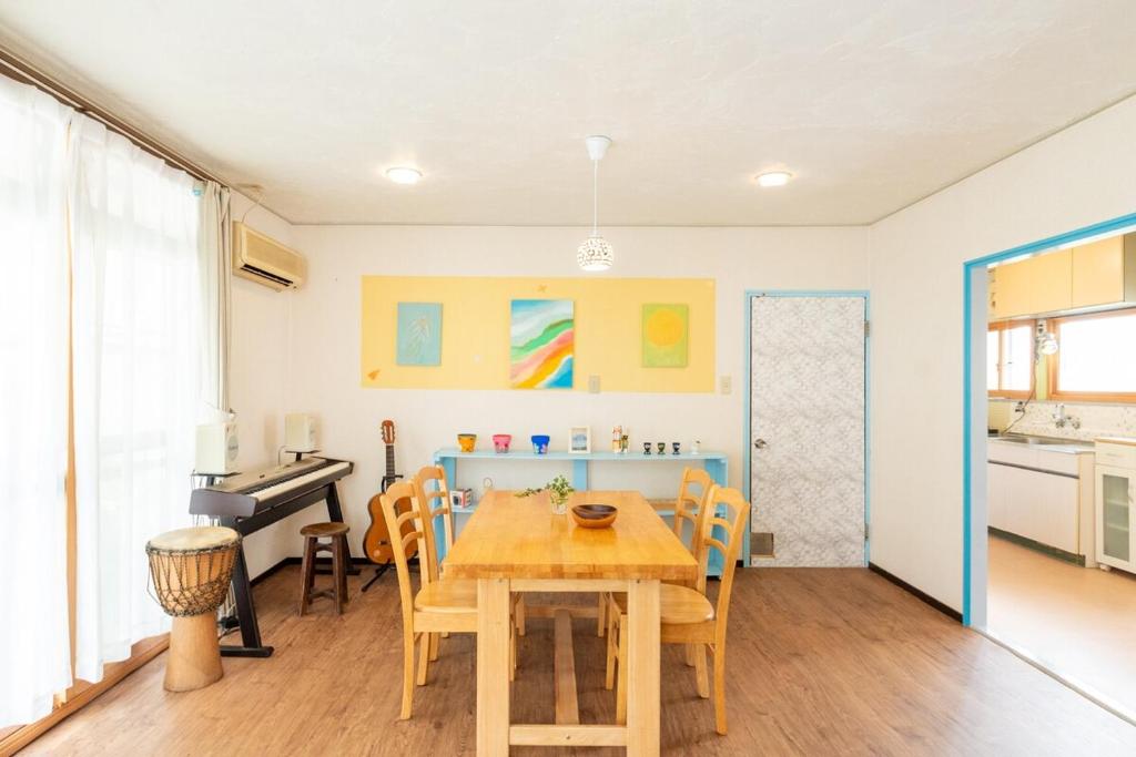 a kitchen and dining room with a wooden table at Joy House in Matsumoto
