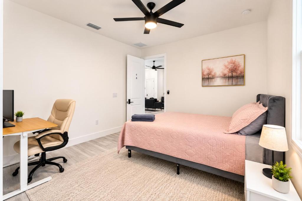a bedroom with a bed and a desk at SpaceX R4 Shared in Orlando