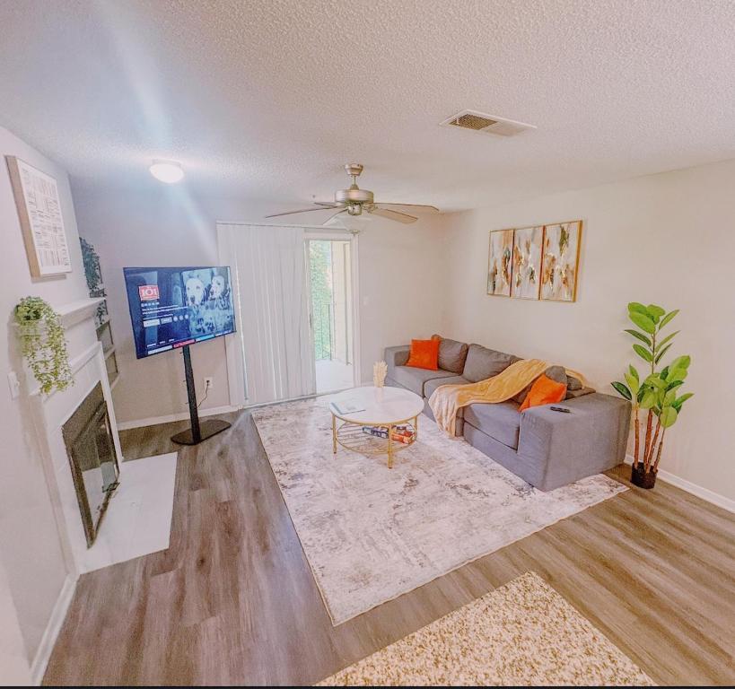 a living room with a couch and a table at Cozy ATL Retreat in Decatur