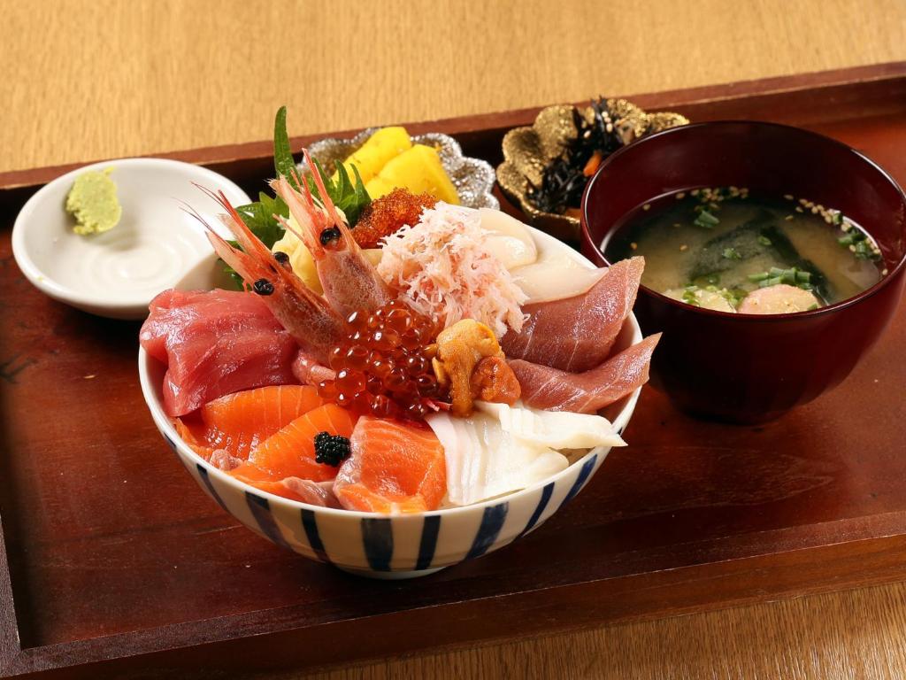 a bowl of sushi and a bowl of soup on a tray at Tabist THE GREEN SAPPORO in Sapporo