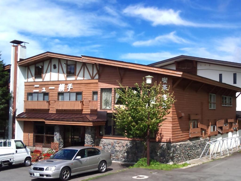 a house with a car parked in front of it at New Yokote in Yamanouchi