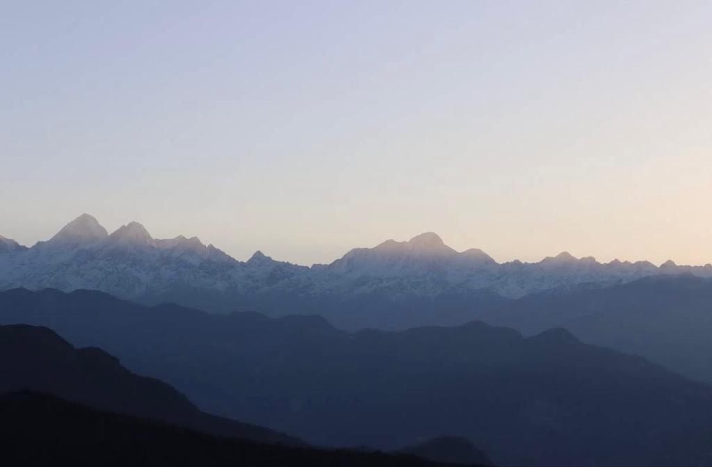 a view of a mountain range at sunset at Hotel Shangbola in Pāti Bhanjyāng