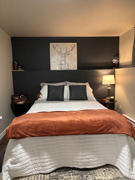 a bedroom with a large bed with two pillows at Eastpoint Cozy Apartment in St. John's