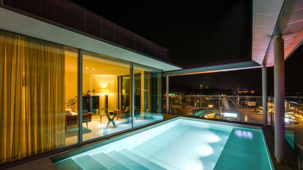 a swimming pool on the balcony of a building at Ripple Boutique Hotel in Yangpyeong